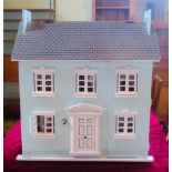 A contemporary dolls house complete with furniture.