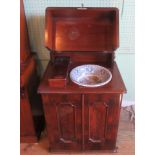 A 19th century mahogany washstand, with rising top above two panelled doors.