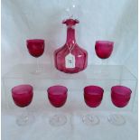 A cranberry decanter, together with six port glasses.