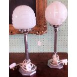 A near matching pair of 20th century chrome table lamps with opaque glass shades.