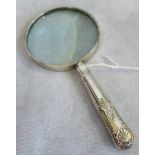 A silver handled magnifying glass.