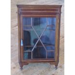 An Edwardian mahogany and inlaid hanging corner cupboard with astragal glazed door.