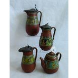 A set of three graduated Prattware lidded jugs, with Greek Key decoration on a terracotta ground,