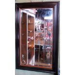 A contemporary black and gilt framed rectangular wall mirror with bevelled plate.