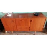 A mid-19th century G-plan style sideboard, having central rising top compartment over two drawers,