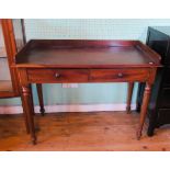 A Victorian mahogany two drawer washstand on ring turned supports.