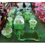 A large collection of 1930's green glass, comprising: candlesticks, table centres,
