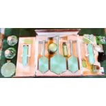 An Art Deco cased dressing table set, comprising: brushes, mirror and various perfume bottles.