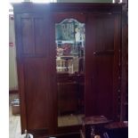 An Edwardian mahogany and inlaid triple wardrobe,