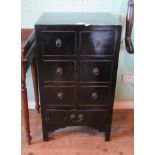 A contemporary black painted chest with six small drawers, over one long drawer on square supports.