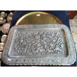 An Indo Moorish circular beaten brass table top tray and a rectangular punch work,