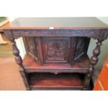 A 19th century oak court cupboard, with profusely carved panels over open lower section.