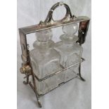 A two bottle tantalus with hinged articulated handle, a silver plated salver,