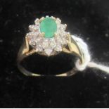 An emerald and diamond cluster ring,