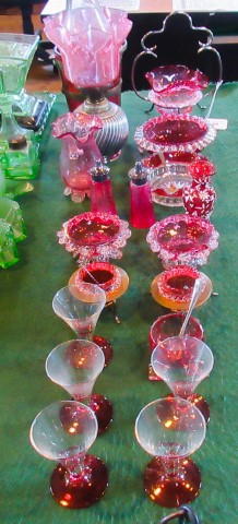 A collection of cranberry glass, to include: oil lamp, ice bucket, salts,