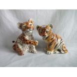 A late 20th century pottery model of a tiger cub, together with a leopard cub.