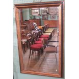 A contemporary black and gilt framed rectangular wall mirror with bevelled plate.