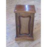 An Edwardian walnut bedside cabinet.