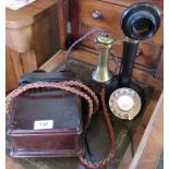 An early 20th century candle telephone, complete with bell.