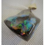 A boulder opal pendant, the rough cut stone to simple yellow metal bale, overall weight 25.2g.