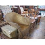 A Lloyd Loom armchair and linen basket, together with an oak captain's chair,