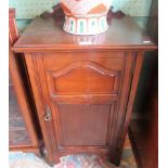 An Edwardian walnut bedside cupboard.