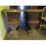 A pair of cast iron garden urns. Condition Report: 69cm high.