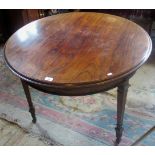 A 19th century rosewood centre table on moulded tapering supports, terminating on brass castors.
