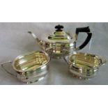 A 20th century hallmarked tea service, comprising: teapot, sugar bowl and milk jug, various dates.