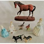 A Royal Doulton horse on stand titled Spirit of Youth, together with three Royal Doulton figurines,