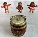 An oak biscuit barrel containing three miniature Steiff hedgehogs.