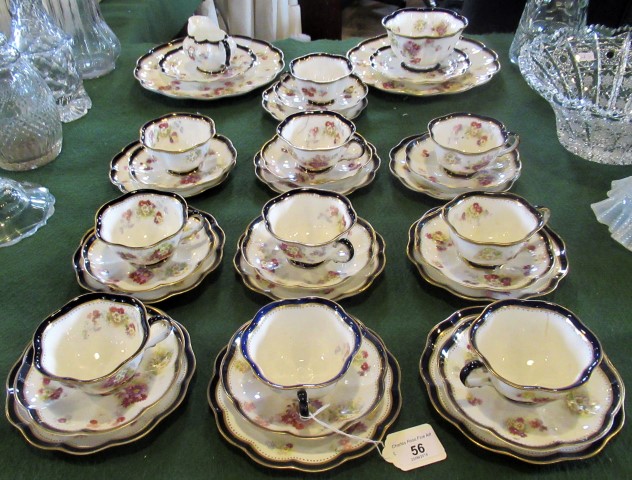 A Victorian part-Crescent Ware tea service, with flower decoration, gilt and blue border,