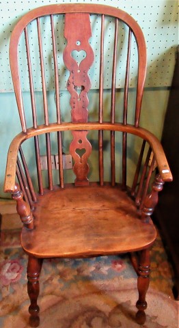 A 19th century oak and elm hooped back Windsor armchair.