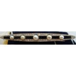 A French Art Deco diamond, onyx and pearl bar brooch,