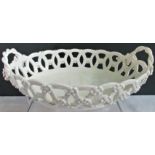 An 18th century Worcester white openwork basket with moulded flowers and rope handles.