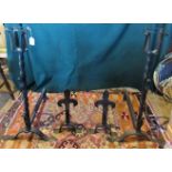 A pair of wrought iron basket candle stands,