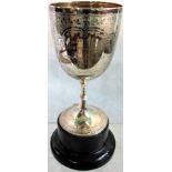 A silver trophy goblet with leaf and floral decoration, having central inscribed cartouche,