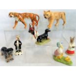 A collection of eight various cabinet ornaments to include: a Beswick tiger,