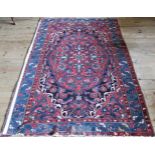A red and blue Hammadam patterned rug, 214 x 143cm.