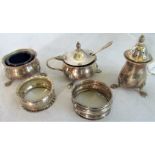 A silver salt, lidded mustard and pepper, spoon and two napkin rings, various dates and makers.