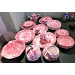 A large collection of pink and white china consisting of plates, bowls, cups,
