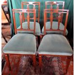 A set of four Edwardian mahogany framed and upholstered dining chairs.