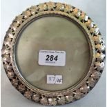 A silver trimmed circular picture frame, Birmingham 1901, 14.5cm diameter.