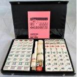 A late 20th century mahjong set in original sealed wrappers, unused, in contemporary case.