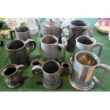 A quantity of pewter tankards and other related items.