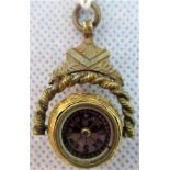 A miniature compass in an engraved spherical 18ct gold mount,