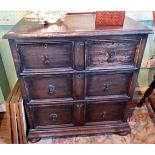 A small 20th century oak chest of two short over two long drawers on bun feet.