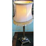 A contemporary brass and marble table lamp with tasselled shade.