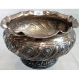 A silver bowl, the scalloped rim over swirl relief decoration on stepped circular base.