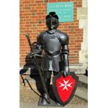 A 20th century suite of armour in the form of a knight,